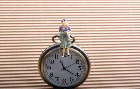 Photo for Paper woman shape and a pocket watch - Royalty Free Image