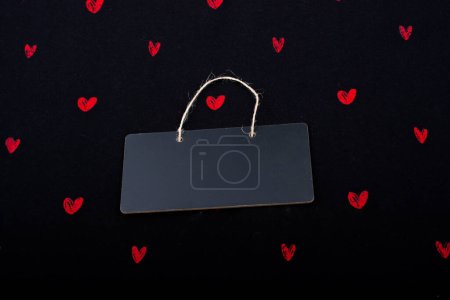 Photo for Rectangular shaped black notice board  and red hearts - Royalty Free Image