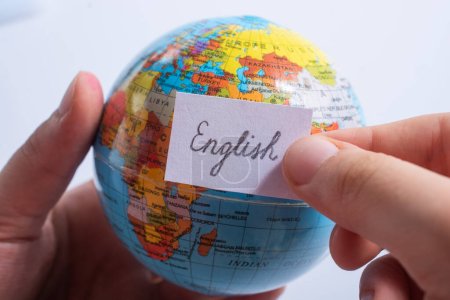 Photo for "Hand holding notepaper with English wording on globe" - Royalty Free Image
