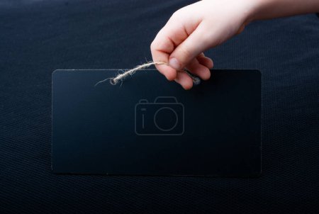 Photo for Rectangular shaped black notice board in hand - Royalty Free Image