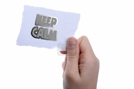 Photo for Blank torn notepaper in hand saying keep calm - Royalty Free Image