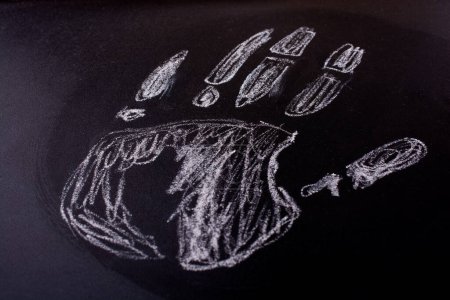 Photo for Handprint drawn by chalk on a blackboard - Royalty Free Image
