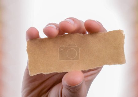 Photo for Blank torn notepaper in hand - Royalty Free Image