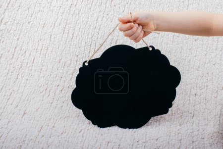 Photo for Black speech bubble shaped notice board in hand - Royalty Free Image