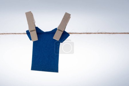 Foto de "Ropa de papel colgada de una cuerda con pinzas de ropa
" - Imagen libre de derechos
