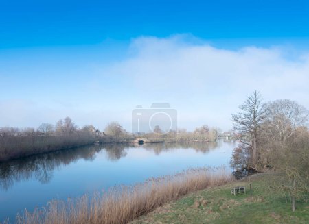Photo for "late winter landscape with water in the centre of holland under blue sky" - Royalty Free Image