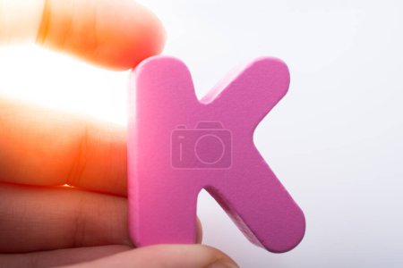 Photo for "Hand holding Letter cube  K of  Alphabet" - Royalty Free Image