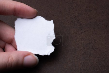 Photo for Blank white torn notepaper in hand - Royalty Free Image