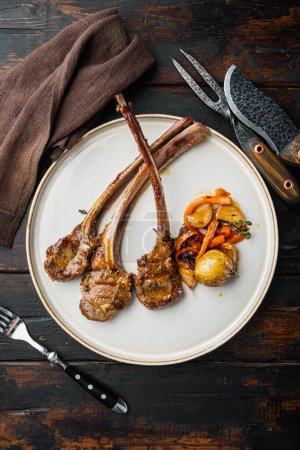 Photo for "Grilled lamb chops with orange and carrot, on plate, top view flat lay" - Royalty Free Image