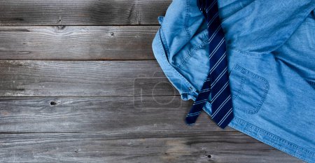 Téléchargez les photos : "Chemise bleue avec cravate sur des planches de bois vintage pour la fête des Pères " - en image libre de droit