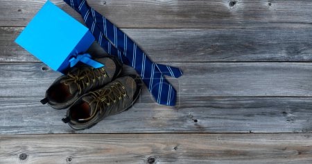 Photo for "Work shoes plus blue necktie and giftbox for Fathers Day holiday background " - Royalty Free Image