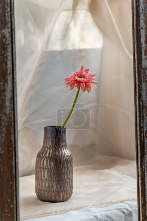 Photo for "Pink flower in Copper color handmade ceramic vase and on Blush textured table cloth. " - Royalty Free Image