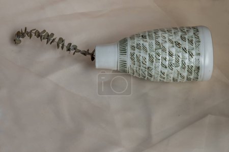 Photo for "Dried flowers in White ceramic vase bottle shape on Blush textured table cloth. " - Royalty Free Image