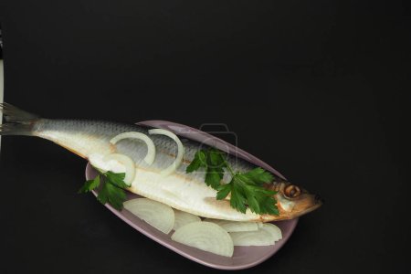 Photo for "Herring is whole, undivided with onion and parsley close-up." - Royalty Free Image