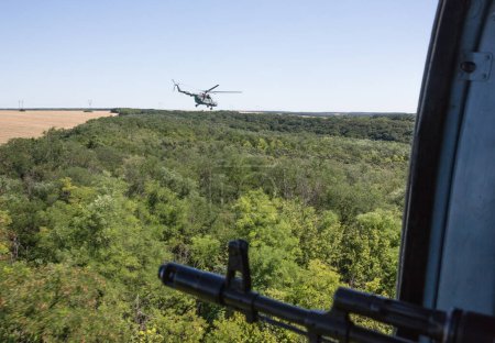 Photo for "Ukrainian army helicopter patrols area of antiterrorist operation" - Royalty Free Image