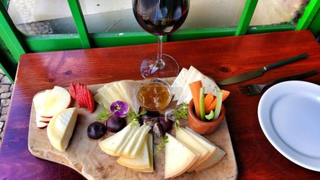 Photo for Varied cheese board, vegetables and wine - Royalty Free Image