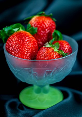 Photo for "cup of ripe strawberries on black background" - Royalty Free Image