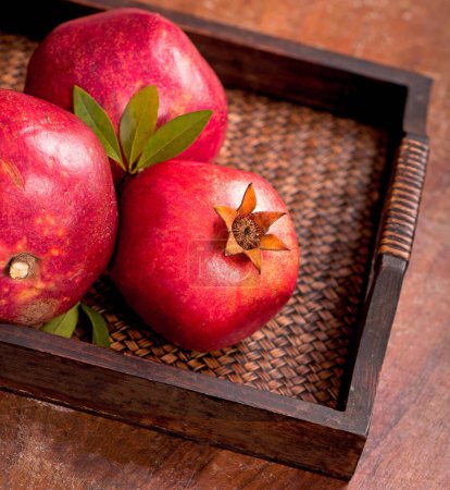 Photo for Ripe pomegranate fruits on the wooden background - Royalty Free Image
