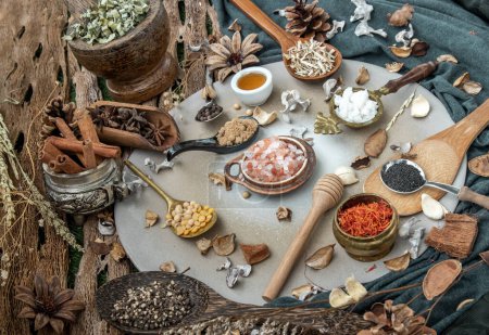 Photo for "Various spices and herbs in rustic style with honey on balck background." - Royalty Free Image
