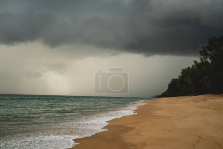 Photo for "Tropical beach with white sand and dark storm clouds." - Royalty Free Image