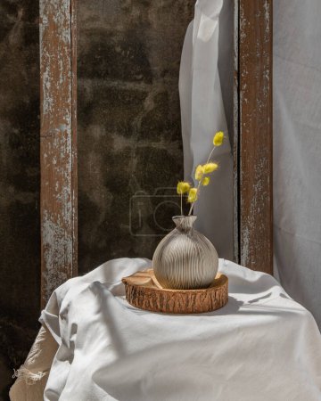 Foto de "Dried flowers in Handmade Ceramic Vases on Wooden Board. Home decor." - Imagen libre de derechos
