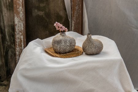 Photo for "Dried flowers in Handmade Double Ceramic Vases on table. Home decor," - Royalty Free Image