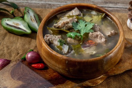 Foto de "Pork spare rip Madan soup (Kra Dook Moo Tom Ma-Dun) in a wooden bowl, Traditional Thai food." - Imagen libre de derechos