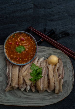 Foto de "Asian food style marinated steamed chicken (Betong Chickken) and sauce on ceramic plate. Serving chilled as an appetizer." - Imagen libre de derechos