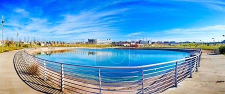 Photo for "Lake in the park. Modern construction of urbanization." - Royalty Free Image