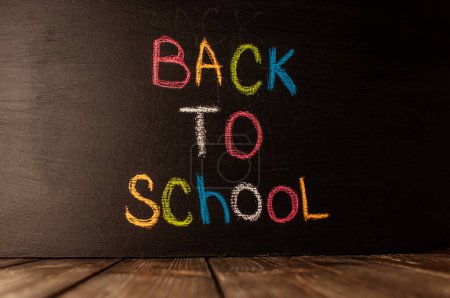 Photo for "Back to school, the concept of parenting. The inscription on the blackboard colored chalk." - Royalty Free Image