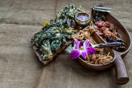 Photo for "Crispy Flowers, Crispy Herbs and Crispy Vegetables served  with Sweet sauce in a Wooden tray." - Royalty Free Image