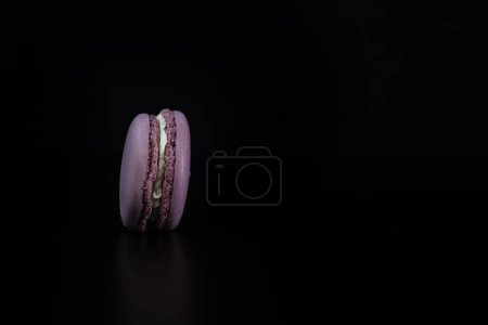Photo for "Colorful tasty macarons isolated on black background, french macarons dessert" - Royalty Free Image