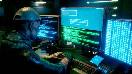 Foto de "A male hacker surrounded by glowing monitors hacks into someone else's computer network in a dark room of his office. 3D Rendering." - Imagen libre de derechos