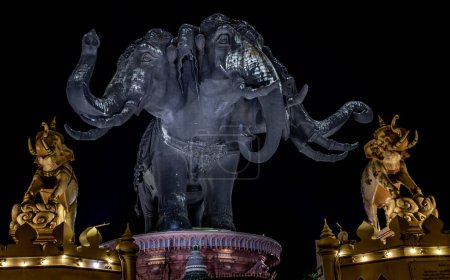 Foto de Museo Erawan es una escultura cabeza elefante con 3 cabezas sobre fondo oscuro noche, Es uno de los turistas importantes y únicos. - Imagen libre de derechos