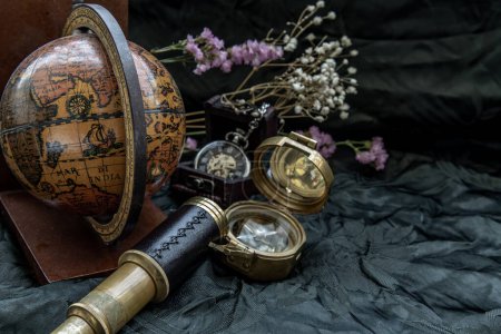 Photo for "Travel or adventure concept background. Pocket watch, binoculars, antique compass, globe and magnifying glass on dark background." - Royalty Free Image