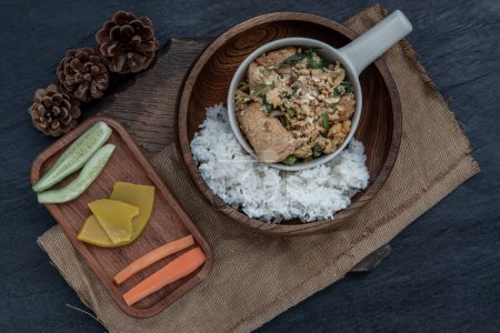 Foto de "Thai food, Stir fried egg tofu with spring onion with Herbs vegetables served with steamed rice in wooden bowl." - Imagen libre de derechos
