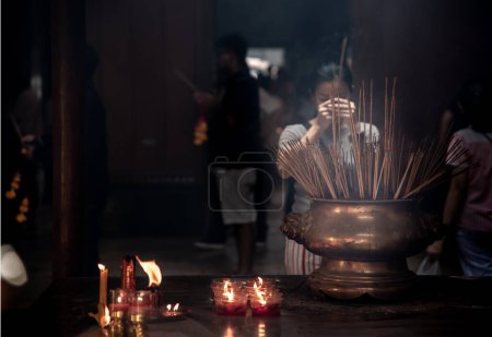 Foto de Interesantes mujeres asiáticas experimentan la cultura religiosa de Tailandia rezando en el Templo del Dragón Kammalawat (Wat Lengnoeiyi), Wat Leng Noei Yi es el templo budista chino más importante de Bangkok. - Imagen libre de derechos