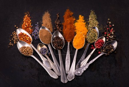 Photo for "Spices and condiments for cooking on a black background" - Royalty Free Image