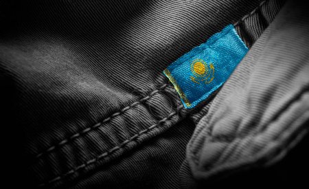 Photo for "Tag on dark clothing in the form of the flag of the Kazakhstan" - Royalty Free Image