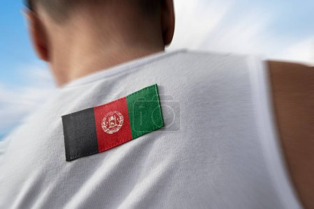 Photo for "The national flag of Afghanistan on the athlete's back" - Royalty Free Image