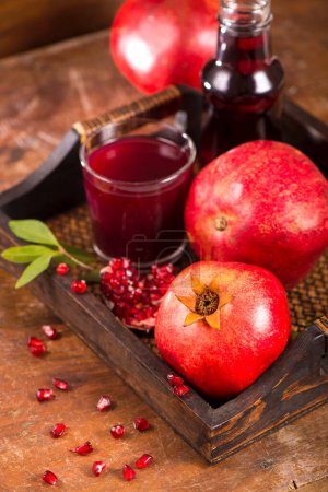 Photo for "Glass of pomegranate juice on a wooden background." - Royalty Free Image