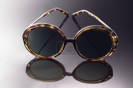 Photo for "Sunglasses on a dark background. Healthy eyes. Advertising object photography." - Royalty Free Image