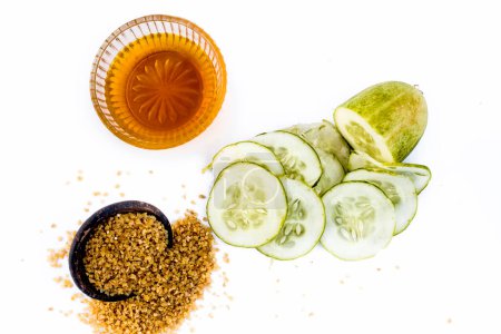 Photo for "Cucumber face pack or face mask isolated on white with its entire ingredients which are oats and honey along with cucumber pulp well mixed in a glass bowl.Good for dry skin." - Royalty Free Image