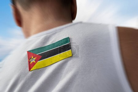 Photo for "The national flag of Mozambique on the athlete's back" - Royalty Free Image