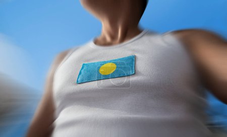 Foto de "The national flag of Palau on the athlete's chest" - Imagen libre de derechos