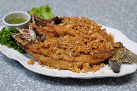 Photo for Stir fried seabass fish on white dish - Royalty Free Image