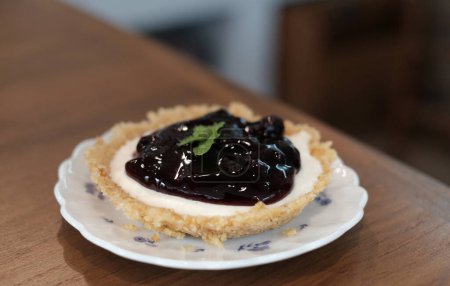 Photo for "closeup blueberry cheese pie on wood table" - Royalty Free Image