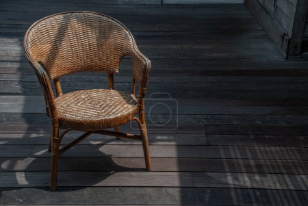 Téléchargez les photos : Chaise en osier sur un balcon confortable sur le balcon de la maison en bois
. - en image libre de droit