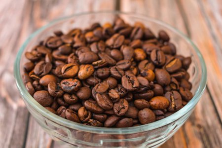 Photo for Ready roasted arabica coffee beans in glass bowl - Royalty Free Image