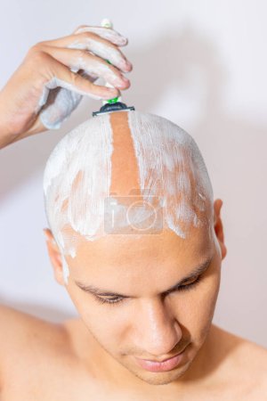 Photo for Man Shaving His Head Using White Foam - Royalty Free Image